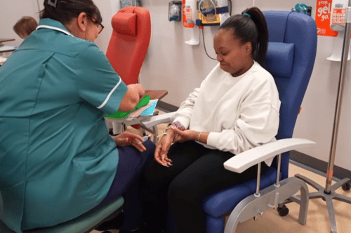 Emma Prescott giving a blood test to Steaphanie George
